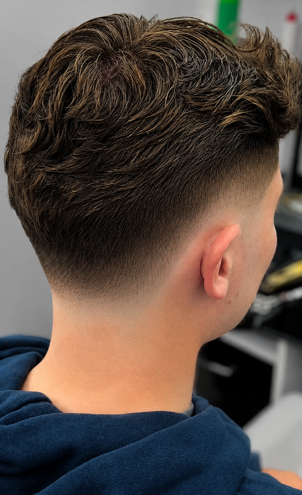 Clean fade haircut finish, close-up detail